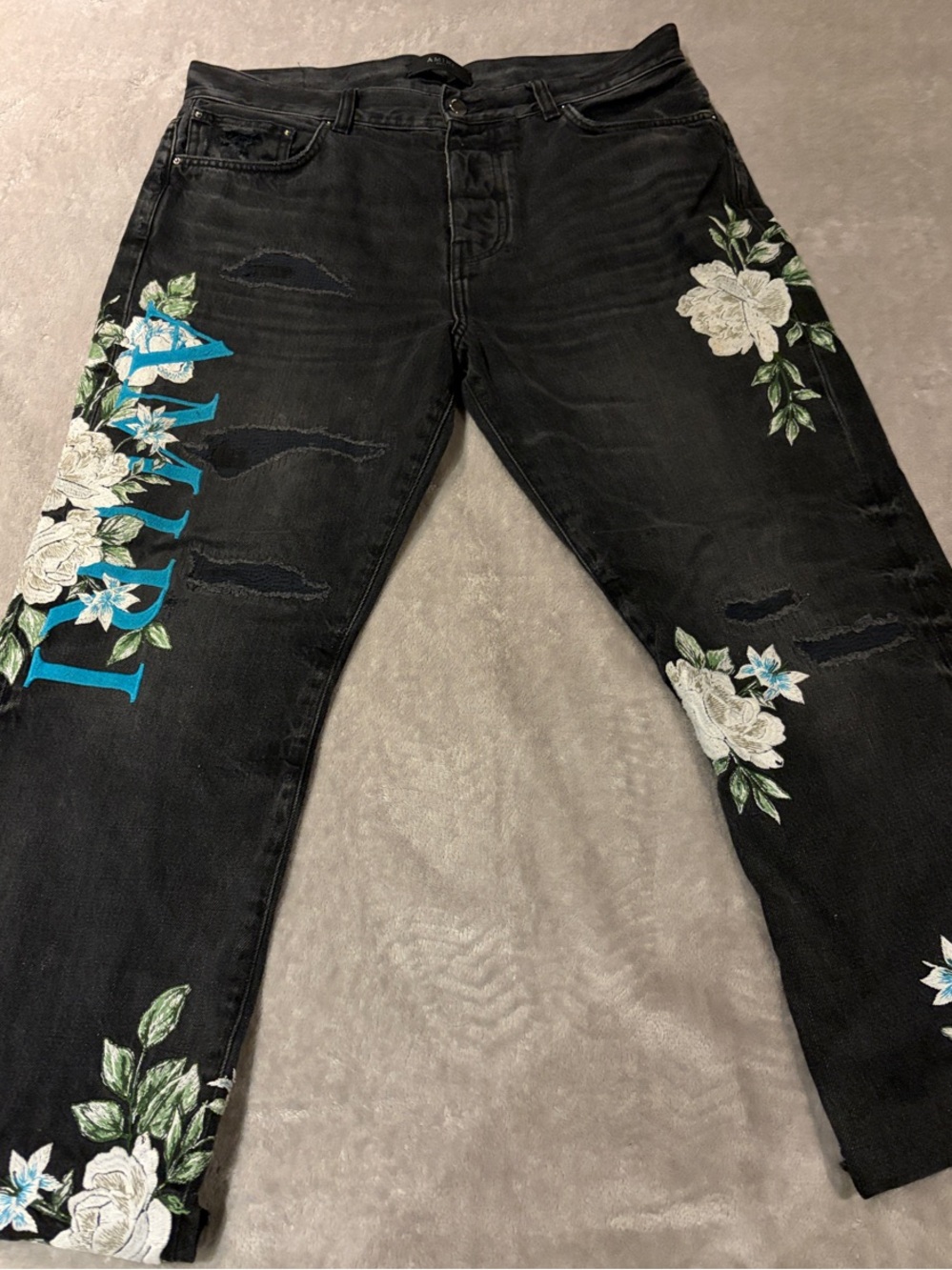 AMIRI Black Straight-Leg Jeans with White Floral Embroidery and Teal Logo